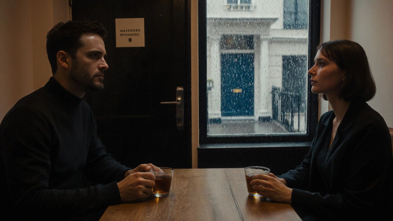 A couple sitting silently with tea in a hidden London studio, rain falling outside the window.