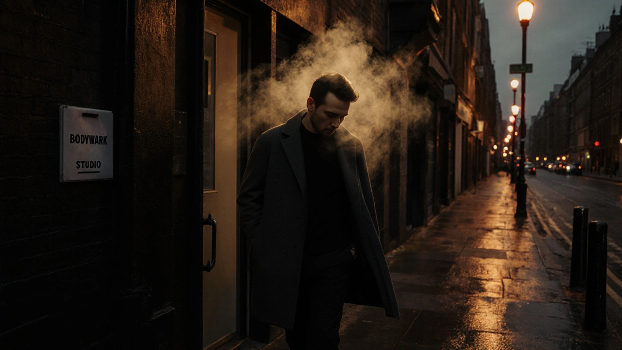 Man walking out of a massage studio in Shoreditch, shoulders relaxed, looking renewed at dusk.