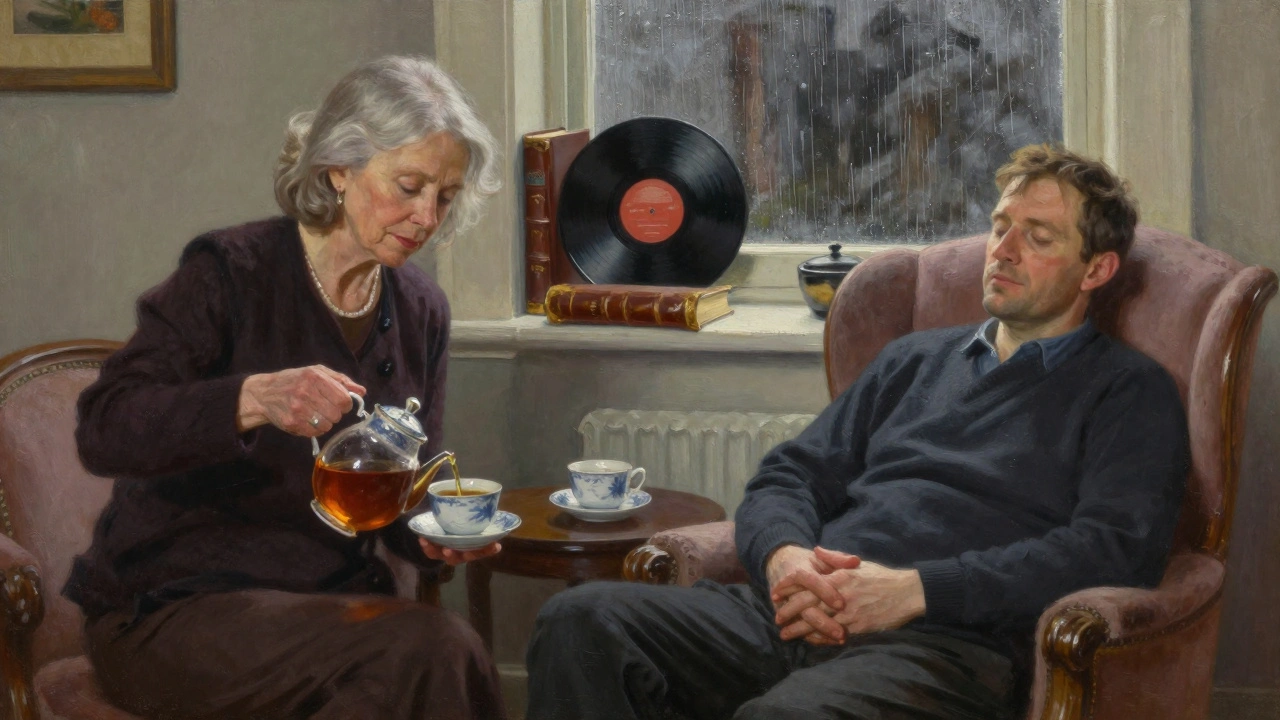 A woman in her 60s pours tea in a quiet Chelsea flat, sharing peaceful moments with a man in a plush armchair.
