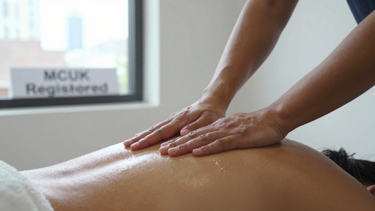 Licensed therapist’s hands applying precise pressure to a client’s back muscle during a therapeutic massage in a Clapham clinic.