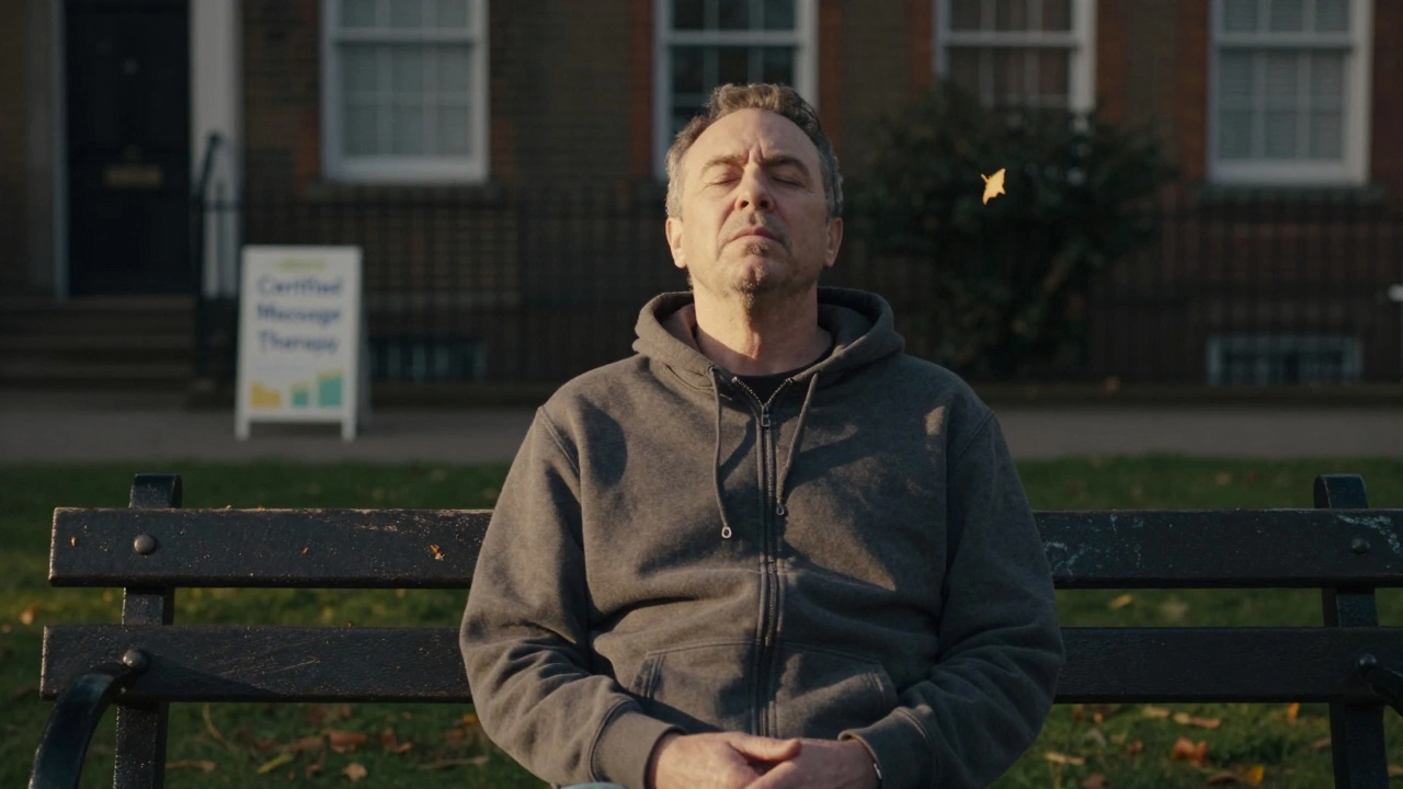 Man sitting peacefully on a park bench at sunset, relaxed and breathing deeply after a healing massage.