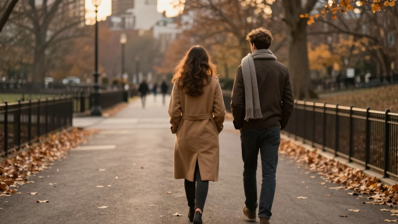 Two figures walking side by side along a leaf-strewn path in Hyde Park at sunset, backs turned, lost in quiet companionship.